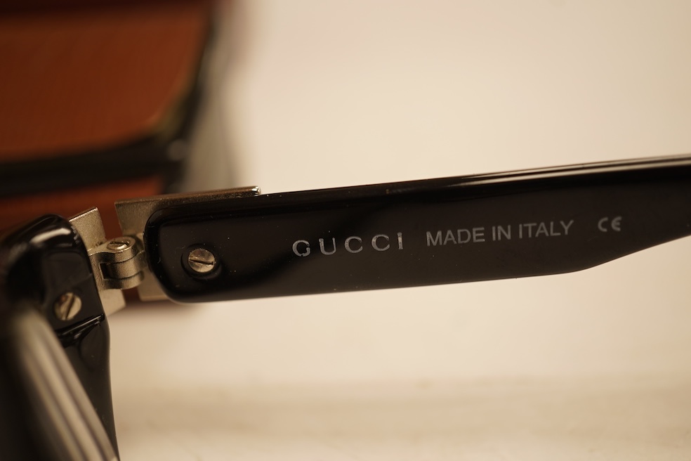 Two pairs of vintage Cartier gilt metal glasses, a pair of Gucci glasses and another